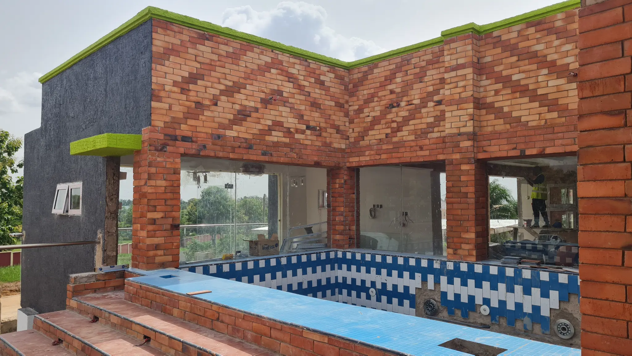 Luxury residential brick facade with pool — completed Bricmates project